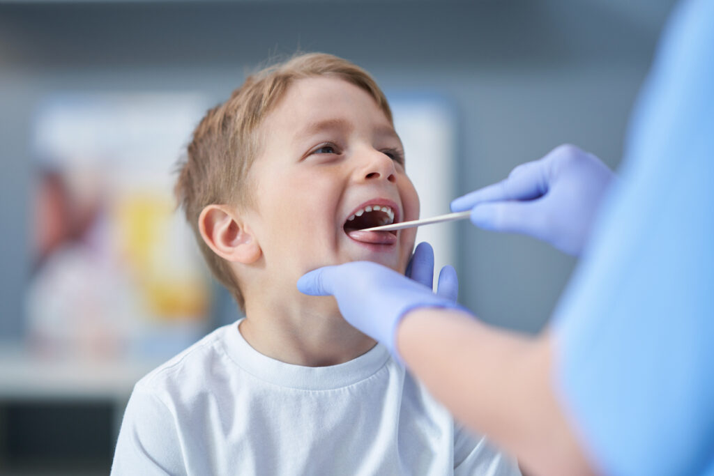 Boy with sore throat, tonsils, adenoids